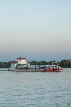 A ferry transporting vehicles across a calm river in Breves, Pará, Brazil during the day.