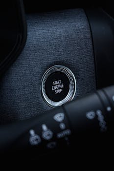 Close-up view of a car's start engine stop button, highlighting modern vehicle interior.