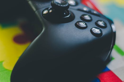 Detailed close-up of a black game controller on a vibrant, colorful background.