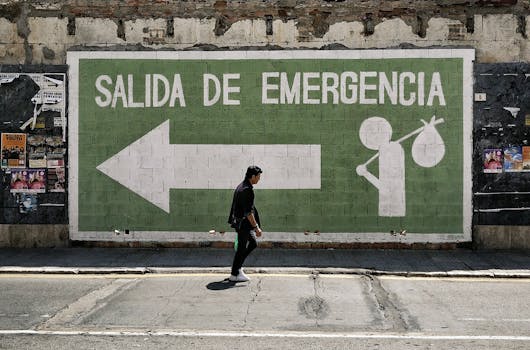 A man walks by an emergency exit graffiti mural on a street in Málaga, Spain.