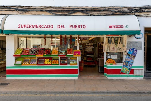 Front view of a vibrant fruit stand at Supermercado Del Puerto in Palma, Spain.